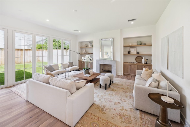 4230 Whitman St, Houston, TX 77027 - living room with built in features, wood finished floors, and a high end fireplace