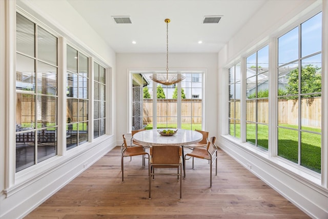 4230 Whitman St, Houston, TX 77027 - sunroom featuring a chandelier, baseboards, wood finished floors, a wooden deck, and recessed lighting