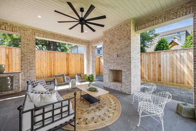 4230 Whitman St, Houston, TX 77027 - view of patio featuring a fenced backyard, an outdoor living space with a fireplace, and a ceiling fan
