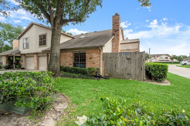 view of side of home featuring brick siding, a garage, a yard, and driveway