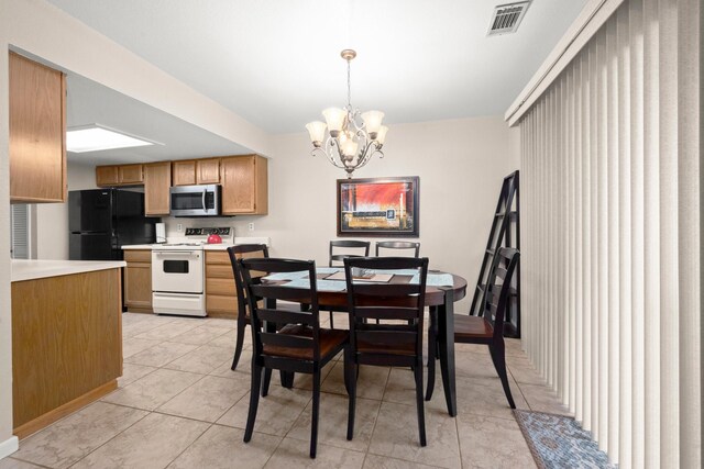 dining area with visible vents, light tile patterned flooring, and an inviting chandelier