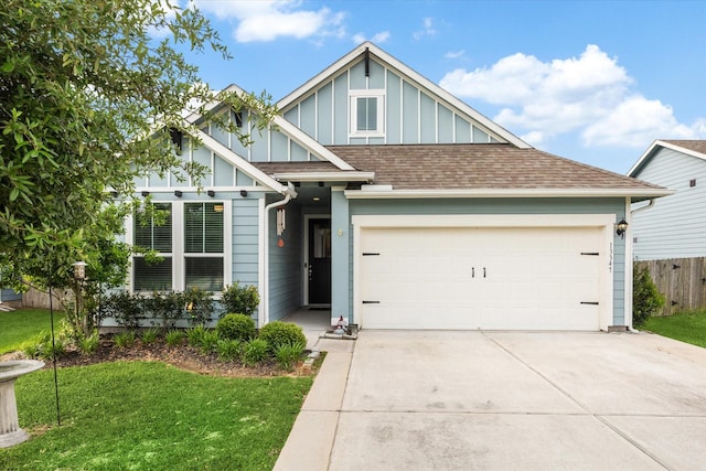 13347 Pecan Trails Dr, Santa Fe, TX 77510 - view of front of house featuring board and batten siding, concrete driveway, an attached garage, and a shingled roof