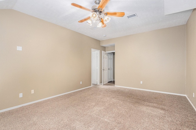 unfurnished room with ceiling fan, visible vents, light carpet, and baseboards