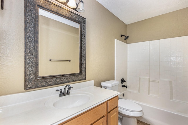 bathroom featuring vanity, a textured wall, shower / tub combination, and toilet