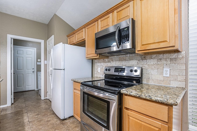 kitchen featuring decorative backsplash, light tile patterned flooring, baseboards, light stone counters, and stainless steel appliances