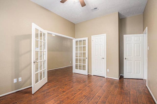 unfurnished room with ceiling fan, wood-type flooring, french doors, baseboards, and visible vents
