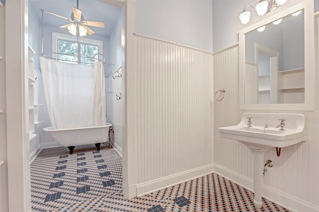 bathroom with a ceiling fan, a bathtub, and curtained shower