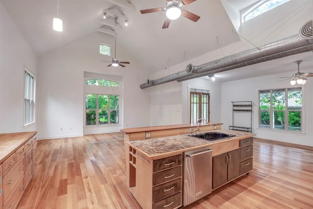 kitchen featuring a sink, high vaulted ceiling, dishwasher, and open floor plan
