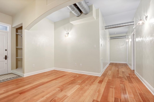 11958 White Oak Path, Conroe, TX 77385 - entrance foyer featuring arched walkways, light wood-style flooring, and baseboards