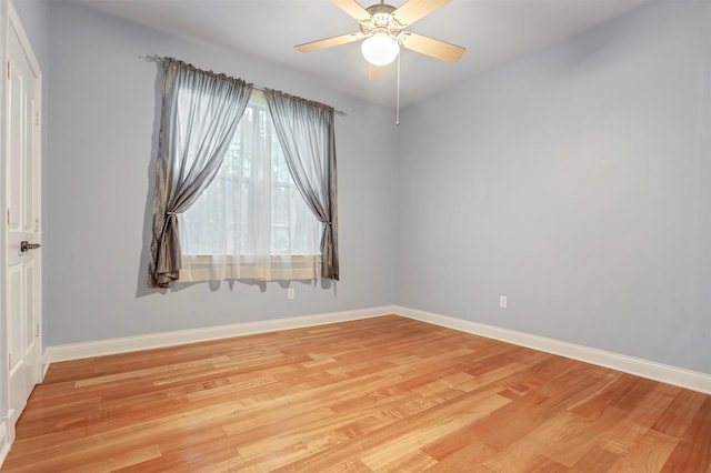 spare room with light wood-style floors, baseboards, and ceiling fan