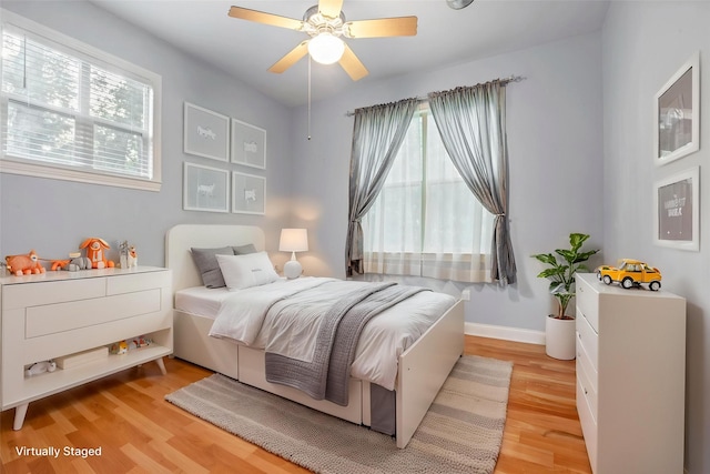 11958 White Oak Path, Conroe, TX 77385 - bedroom featuring light wood-style flooring, baseboards, and ceiling fan