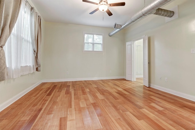 11958 White Oak Path, Conroe, TX 77385 - empty room with ceiling fan, light wood-style flooring, and baseboards