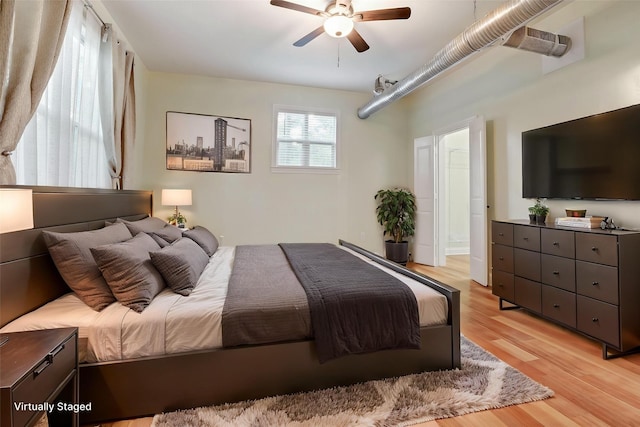 bedroom with ceiling fan and light wood-style flooring
