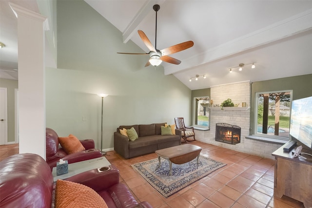 2711 N Saddlebrook Ln, Katy, TX 77494 - living room with a fireplace, tile patterned flooring, lofted ceiling with beams, and a ceiling fan