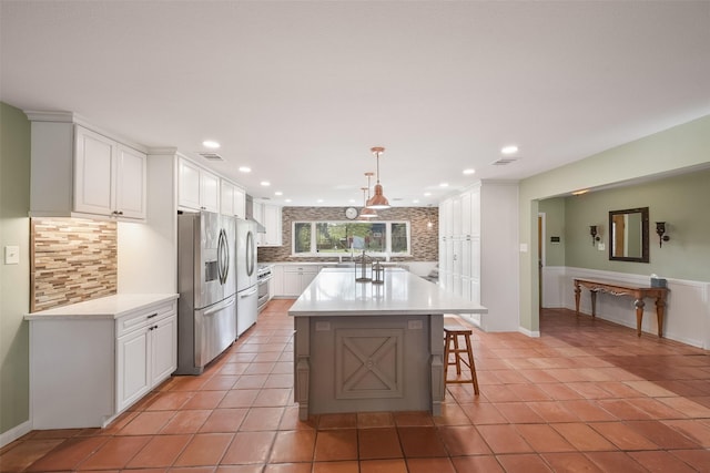 2711 N Saddlebrook Ln, Katy, TX 77494 - kitchen with stainless steel fridge with ice dispenser, light countertops, white cabinetry, recessed lighting, and tasteful backsplash