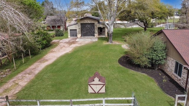 2711 N Saddlebrook Ln, Katy, TX 77494 - view of yard with an outdoor structure, dirt driveway, a garage, and fence