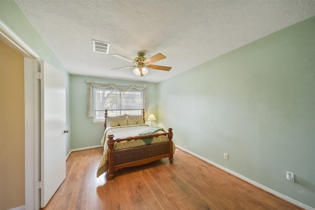 2711 N Saddlebrook Ln, Katy, TX 77494 - bedroom with visible vents, a ceiling fan, baseboards, and wood finished floors