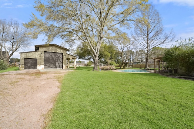 2711 N Saddlebrook Ln, Katy, TX 77494 - view of yard with fence, a garage, a fenced in pool, an outdoor structure, and driveway
