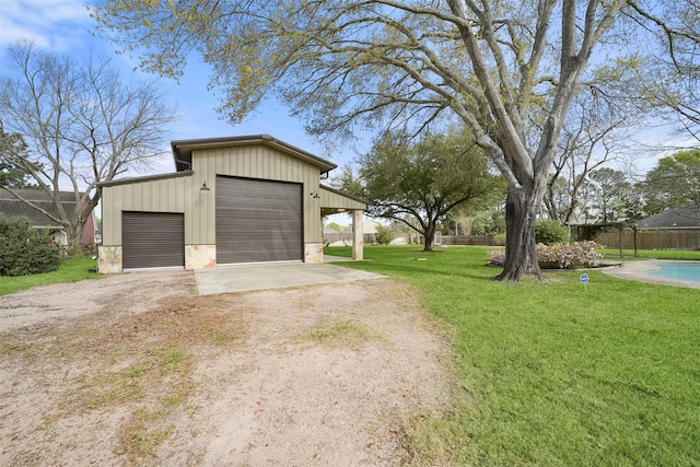 2711 N Saddlebrook Ln, Katy, TX 77494 - garage featuring fence, a detached garage, and driveway