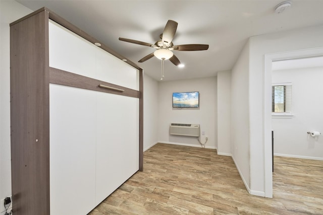 2711 N Saddlebrook Ln, Katy, TX 77494 - corridor featuring baseboards, a wall mounted air conditioner, and light wood finished floors