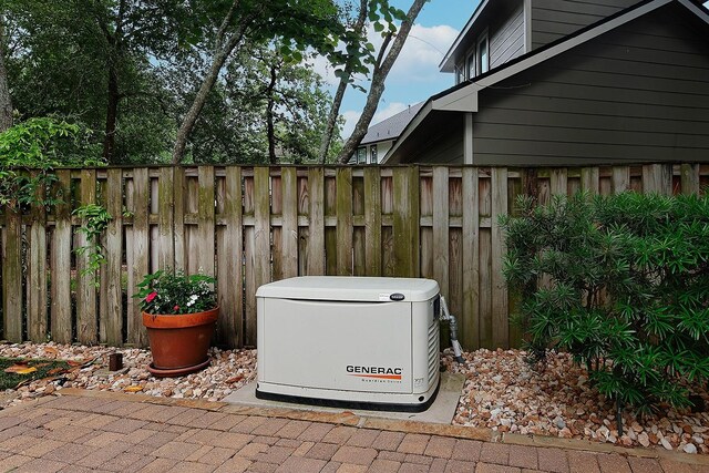 details featuring fence and a power unit
