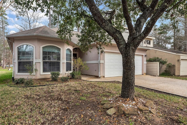 11542 Twain Dr, Montgomery, TX 77356 - view of front facade featuring concrete driveway, an attached garage, roof with shingles, and stucco siding