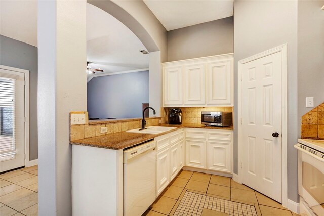 11542 Twain Dr, Montgomery, TX 77356 - kitchen with white dishwasher, a sink, stainless steel microwave, decorative backsplash, and light tile patterned floors