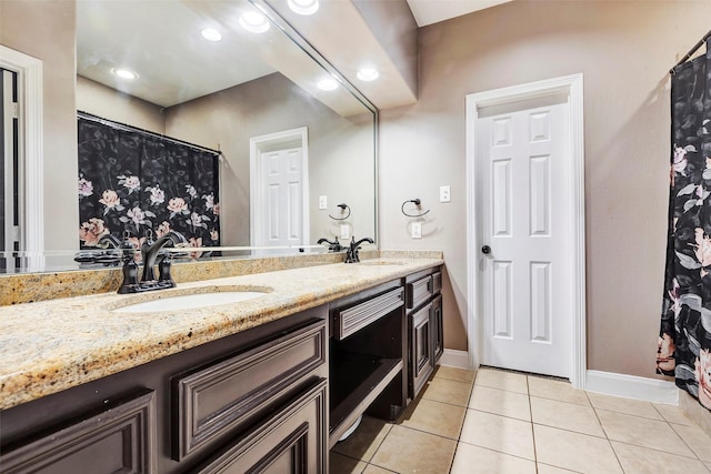11542 Twain Dr, Montgomery, TX 77356 - bathroom featuring double vanity, baseboards, a sink, and tile patterned flooring