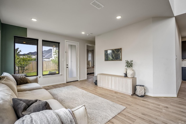 living area featuring recessed lighting, baseboards, visible vents, and light wood-style floors