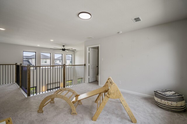 interior space featuring carpet floors, baseboards, and visible vents