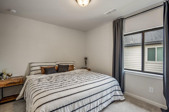 bedroom with baseboards, multiple windows, carpet, and visible vents