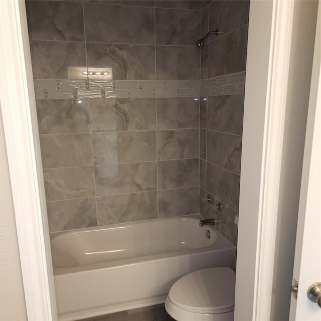 full bath featuring toilet and washtub / shower combination