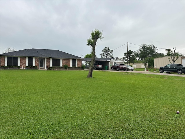 4060 Dubuque Pkwy, Rosharon, TX 77583 - ranch-style house featuring a carport, driveway, a front lawn, and brick siding