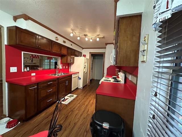 4060 Dubuque Pkwy, Rosharon, TX 77583 - kitchen with dark wood-type flooring, a sink, a textured ceiling, and white appliances