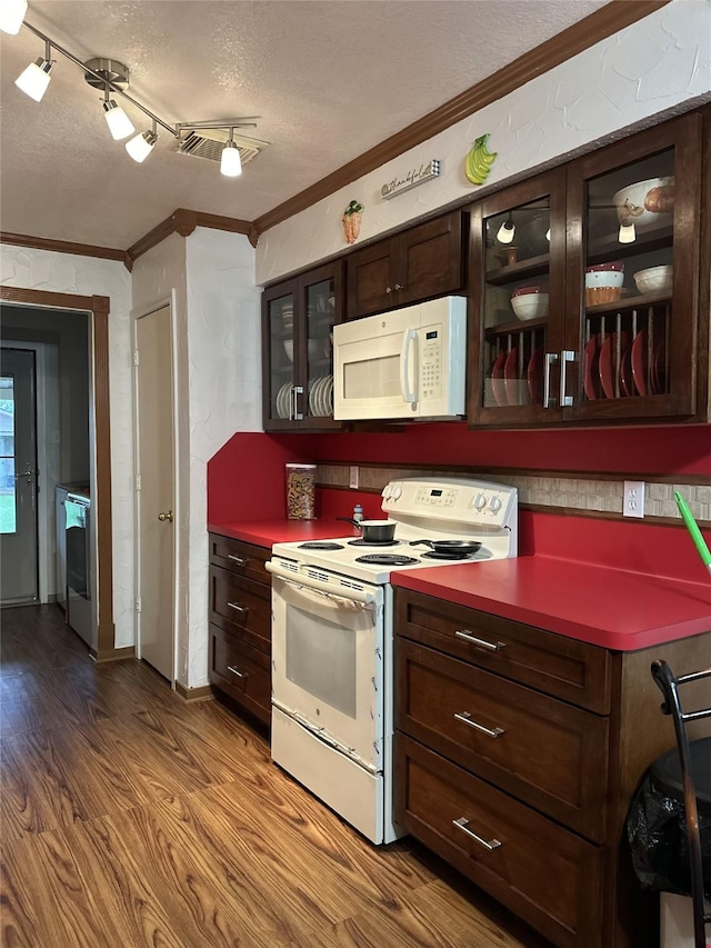 4060 Dubuque Pkwy, Rosharon, TX 77583 - kitchen with crown molding, white appliances, a textured ceiling, wood finished floors, and glass insert cabinets