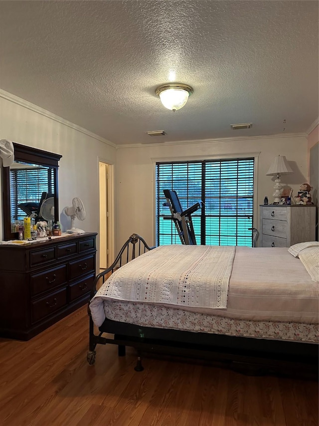 4060 Dubuque Pkwy, Rosharon, TX 77583 - bedroom with a textured ceiling, wood finished floors, and visible vents