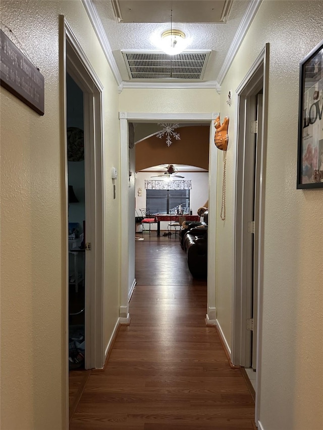 4060 Dubuque Pkwy, Rosharon, TX 77583 - hallway with crown molding, baseboards, visible vents, and wood finished floors