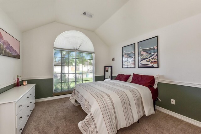 bedroom with visible vents, baseboards, lofted ceiling, and light colored carpet