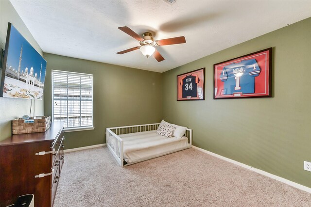 carpeted bedroom with baseboards and a ceiling fan
