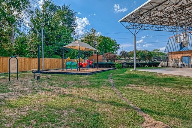 community play area with a yard and fence