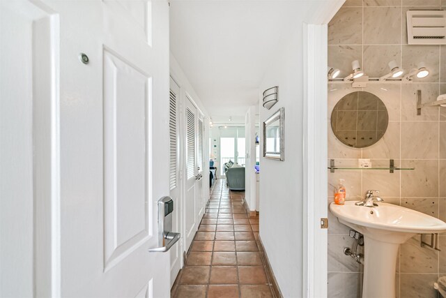 bathroom with tile patterned flooring and tile walls