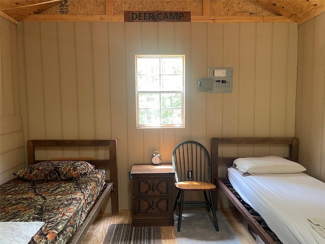 bedroom featuring vaulted ceiling and a wall mounted air conditioner