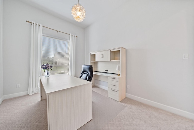 office area with an inviting chandelier, baseboards, and light colored carpet