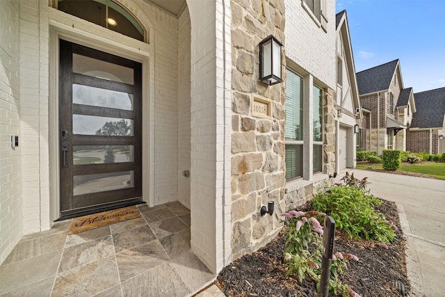 doorway to property with stone siding