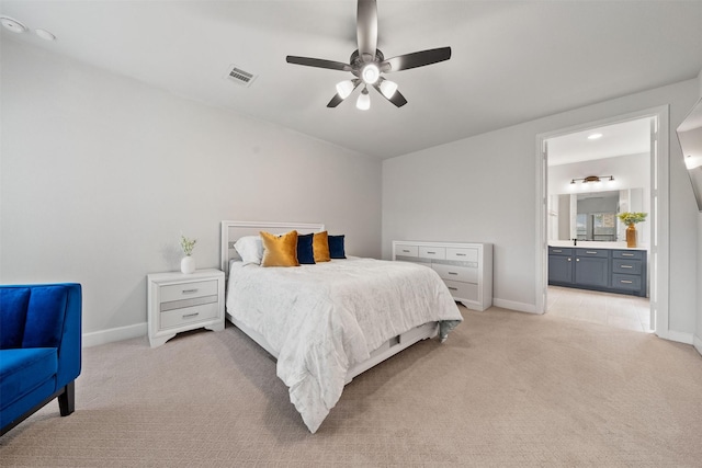 bedroom featuring baseboards, light carpet, and visible vents