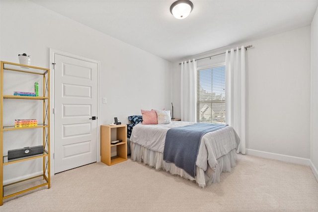 carpeted bedroom featuring baseboards
