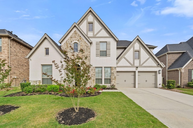 tudor house featuring concrete driveway, a garage, stone siding, and a front lawn