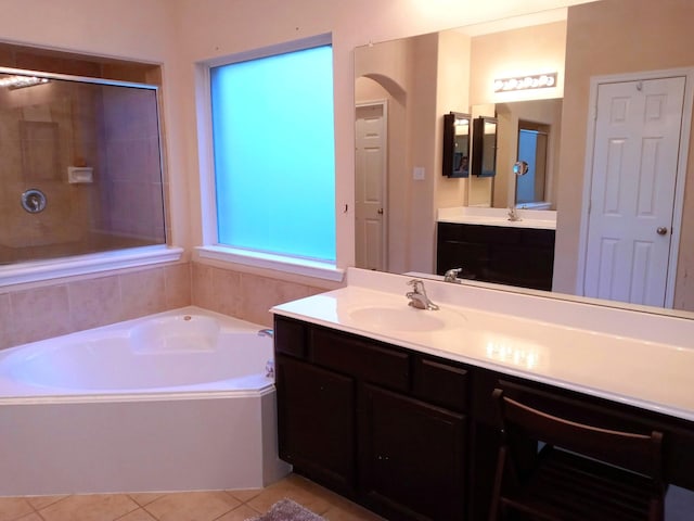 bathroom featuring vanity, tile patterned flooring, a tile shower, and a bath