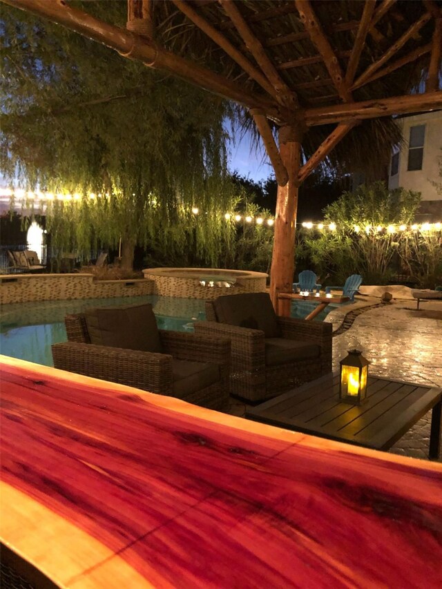 view of patio / terrace featuring a hot tub and an outdoor pool