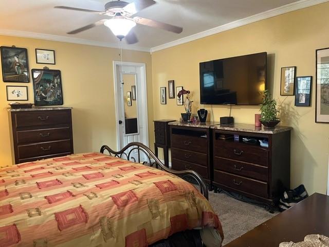 bedroom featuring ornamental molding and ceiling fan